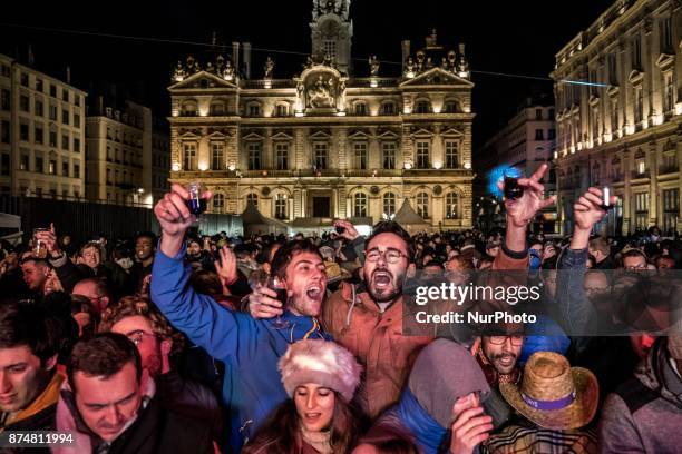 People celebrate the official launch of the Beaujolais Nouveau wine on November 15, 2017 in Lyon, France. The tradition is that the first barrel of...