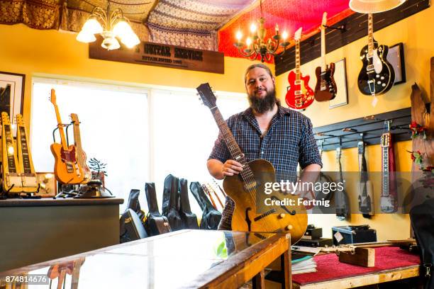 luthier in his guitar repair shop - guitar shop stock pictures, royalty-free photos & images