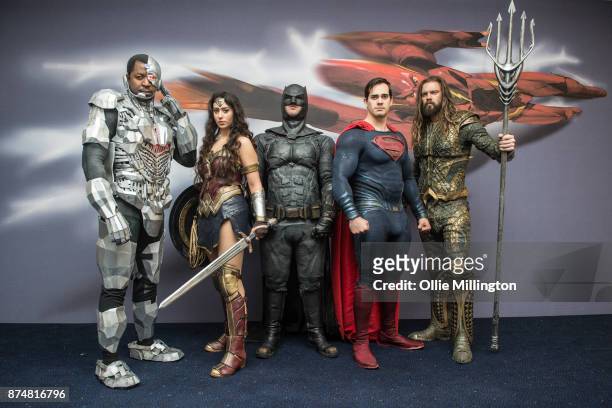 The character Cyborg, Wonder Woman, Batman, Superman and Aquaman from the Justice League film pose in character infront of film based promotional...