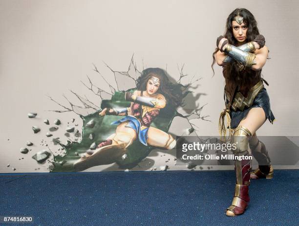 The character Wonder Woman from the Justice League film poses in character infront of film based promotional artwork unveiled for the first time...