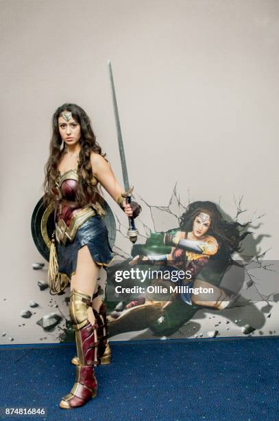 The character Wonder Woman from the Justice League film poses in character infront of film based promotional artwork unveiled for the first time...