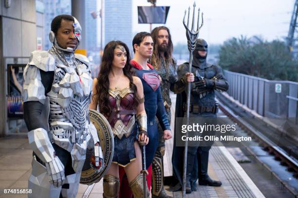 The characters Cyborg; Wonder Woman, Superman; Aquaman and Batman from the Justice League film pose in character on the London Underground during a...