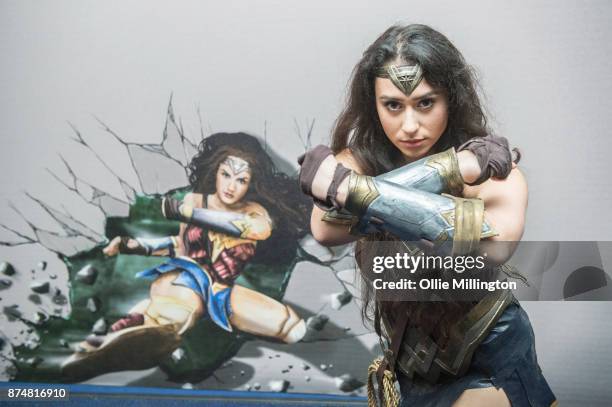 The character Wonder Woman from the Justice League film poses in character infront of film based promotional artwork unveiled for the first time...