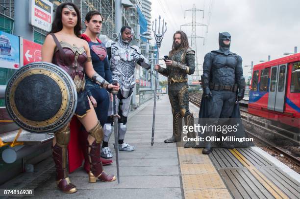 The characters Wonder Woman, Superman, Cyborg and Batman from the Justice League film pose in character on the London Underground during a photocall...