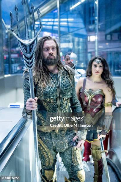 The characters Aquaman and Wonder Woman from the Justice League film pose in character on the London Underground during a photocall en route to The...