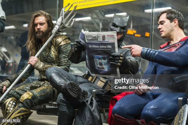 Characters Aquaman, Batman and Superman from the Justice League film pose in character at the end of a photocall accross London after the UK premier...