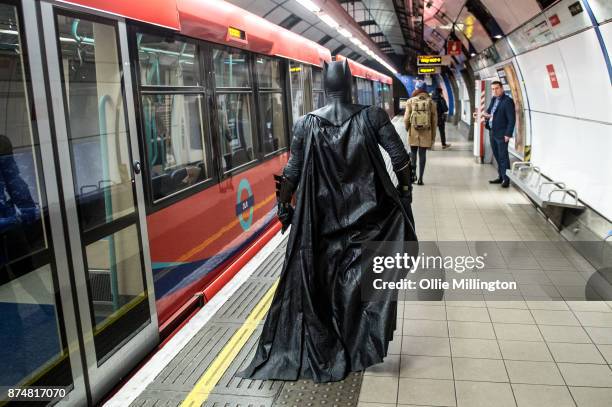 The character Batman from the Justice League film poses in character on the London Underground during a photocall en route to The Leicester Square...