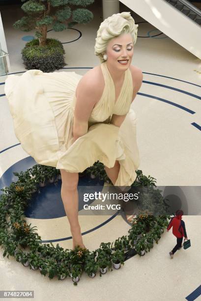 An eight-meter-tall sculpture of American actress and model Marilyn Monroe is exhibited at a shopping mall on November 14, 2017 in Dalian, Liaoning...