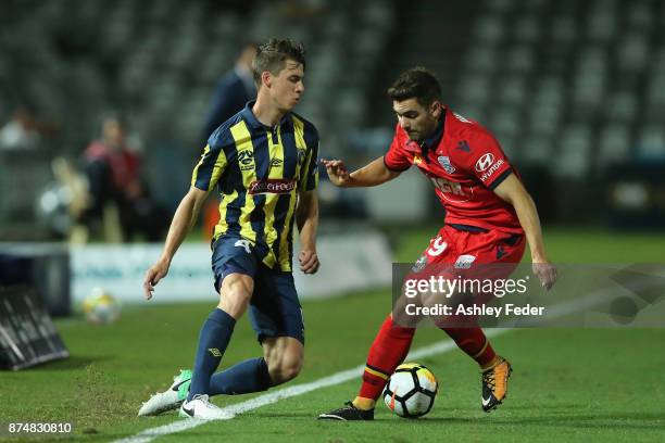 Jake McGing of the Mariners contests the ball against Benjamin Garrucio of Adelaide during the round seven A-League match between the Central Coast...