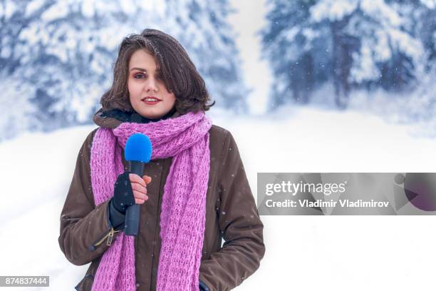 young tv reporter in winter forest - weather forecaster stock pictures, royalty-free photos & images