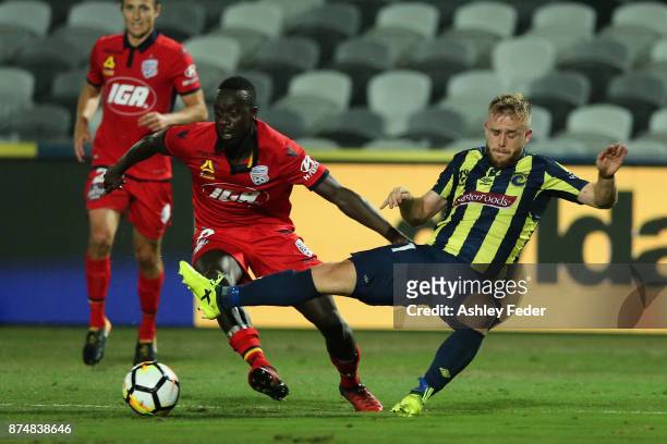 Connor Pain of the Mariners is fouled by Papa Babacar Diawara of Adelaide resulting in a penalty kick during the round seven A-League match between...