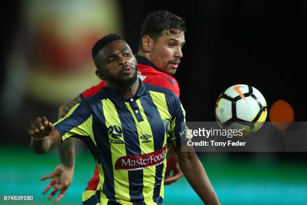 Kwabena Appiah of the Mariners contests the ball with his Adelaide United opponent during the round seven A-League match between the Central Coast...