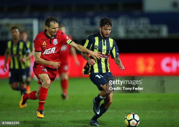 Isaias of Adelaide United contests the ball with Daniel De Silva of the Mariners during the round seven A-League match between the Central Coast...