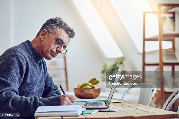 making sure everything is filled in - middle aged man stock pictures, royalty-free photos & images
