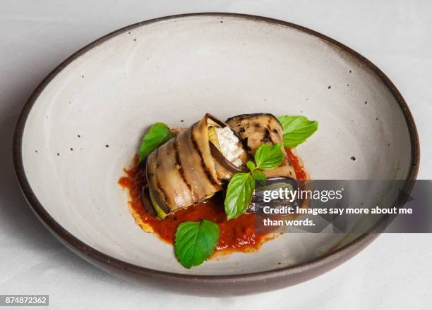 a vegetarian cannelloni prepared with eggplant, buffalo mozzarella and tomato sauce. - cannelloni stock-fotos und bilder