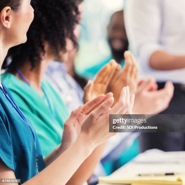 unrecognizable medical professionals applaud speaker during conference - applauding nurses stock pictures, royalty-free photos & images