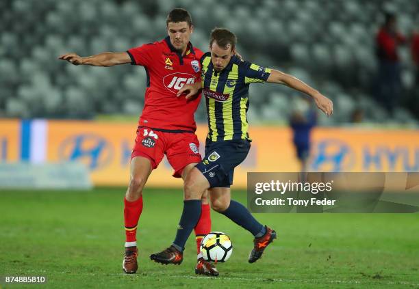 Wout Brama of the Mariners contests the ball with George Blackwood of Adelaide United during the round seven A-League match between the Central Coast...