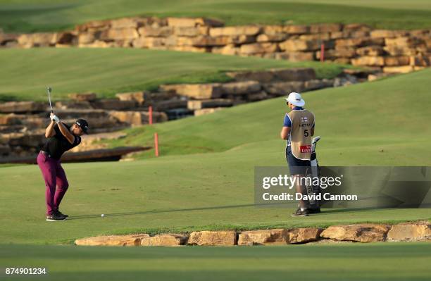 Tyrrell Hatton of England plays his third shot on the 18th hole during the first round of the DP World Tour Championship on the Earth Course at...