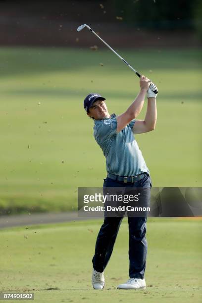 Paul Dunne of Ireland plays his third shot on the 18th hole during the first round of the DP World Tour Championship on the Earth Course at Jumeirah...