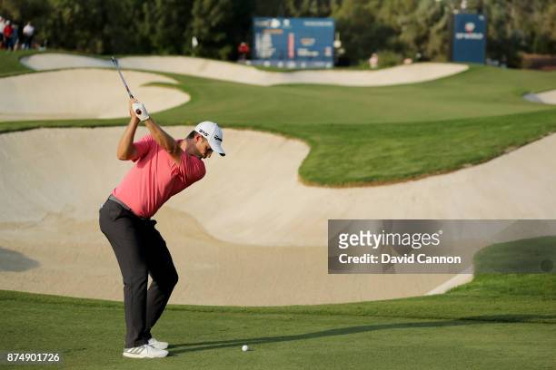 Justin Rose of England plays his second shot on the 15th hole during the first round of the DP World Tour Championship on the Earth Course at...