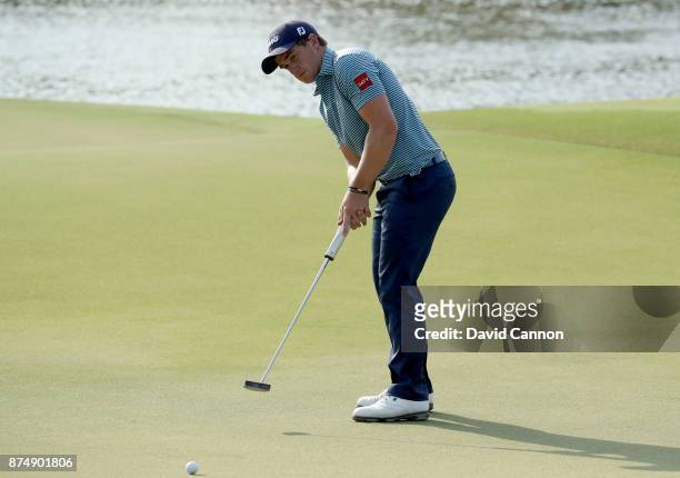 Paul Dunne of Ireland hits a putt on the 16th hole during the first round of the DP World Tour Championship on the Earth Course at Jumeirah Golf...