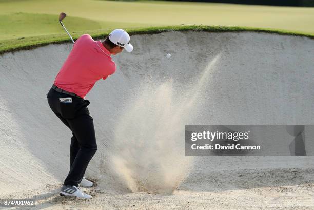 Justin Rose of England plays his third shot which he holed for an eagle on the par 5, 14th hole during the first round of the DP World Tour...