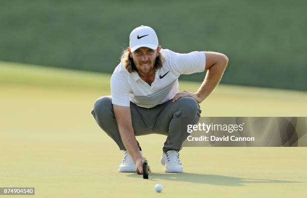 Tommy Fleetwood of England lines up a putt on the 14th hole during the first round of the DP World Tour Championship on the Earth Course at Jumeirah...