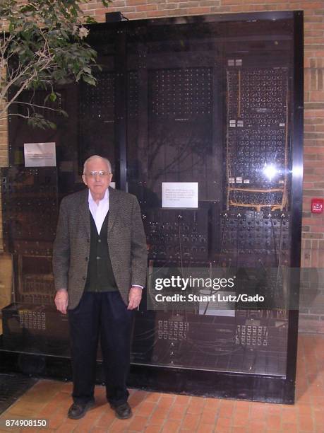 Full-length portrait of mathematician Arthur Burks posing with the ENIAC computer which he helped to design, University of Michigan, Ann Arbor,...