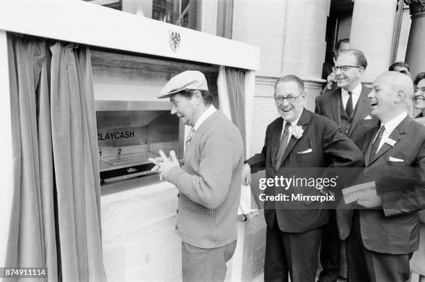 The Worlds First ATM, Cash Machine is unveiled at Barclays Bank, in Enfield, Middlesex, just North of London, 27th June 1967. Picture shows actor Reg...
