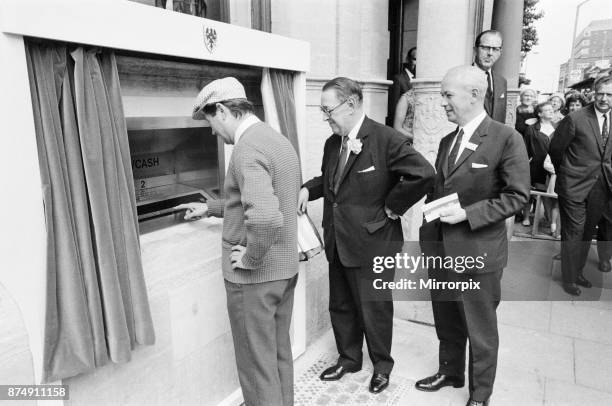 The Worlds First ATM, Cash Machine is unveiled at Barclays Bank, in Enfield, Middlesex, just North of London, 27th June 1967. Picture shows actor Reg...