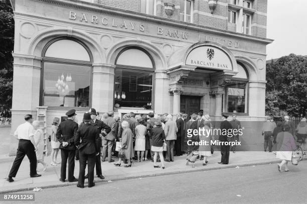 The Worlds First ATM, Cash Machine is unveiled at Barclays Bank, in Enfield, Middlesex, just North of London, 27th June 1967. Picture shows the crowd...