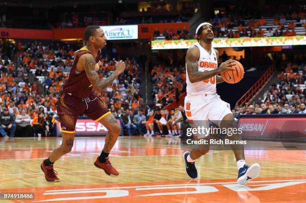 Geno Thorpe of the Syracuse Orange drives to the basket past Zach Lewis of the Iona Gaels during the first half at the Carrier Dome on November 14,...