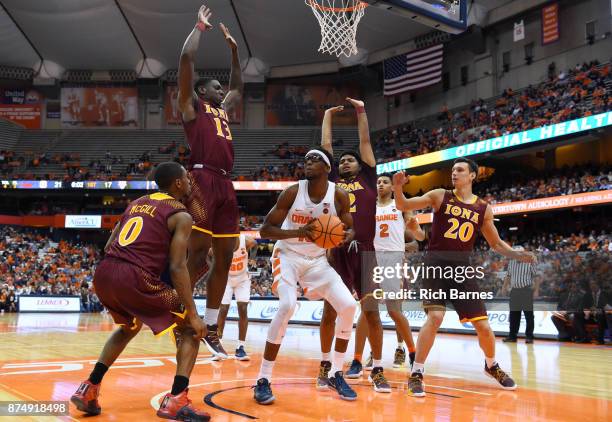 Paschal Chukwu of the Syracuse Orange drives to the basket around a group of Iona Gaels defenders during the first half at the Carrier Dome on...