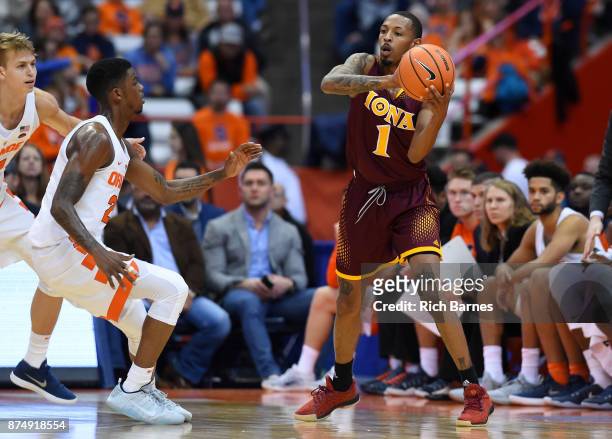 Zach Lewis of the Iona Gaels passes the ball as Frank Howard of the Syracuse Orange defends during the first half at the Carrier Dome on November 14,...