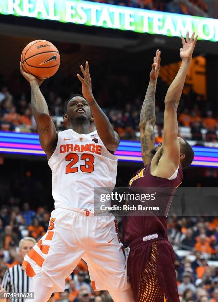 Frank Howard of the Syracuse Orange shoots the ball around Zach Lewis of the Iona Gaels during the second half at the Carrier Dome on November 14,...