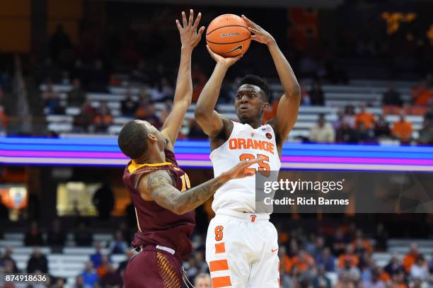 Tyus Battle of the Syracuse Orange shoots the ball against the defense of Zach Lewis of the Iona Gaels during the second half at the Carrier Dome on...