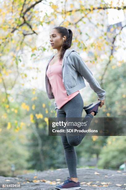 healthy young woman stretches quadricep before morning job - quadriceps muscle stock pictures, royalty-free photos & images