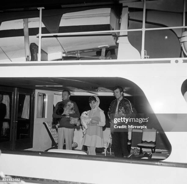 Enjoying a rather expensive quarantine, the dogs of Elizabeth Taylor and Richard Burton are aboard the family yacht moored off Tower Pier. The...