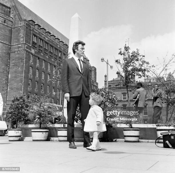 6ft 3 Clint Eastwood, pictured in St Peter's Square, Manchester, with Antony Rixon, aged 18 months. Antony is 32 inches tall, 12th June 1967.