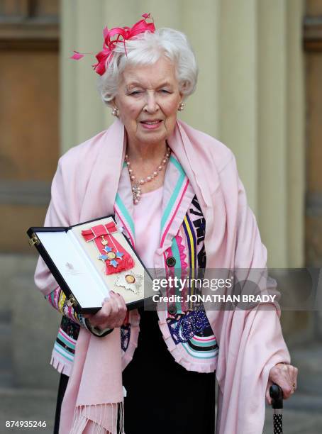 British actress June Whitfield poses with her award after she was appointed Dame by the Prince of Wales during an Investiture ceremony at Buckingham...