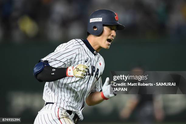 Outfielder Seiji Uebayashi of Japan celebrates hitting a three-run homer to make it 7-7 in the bottom of tenth inning during the Eneos Asia...