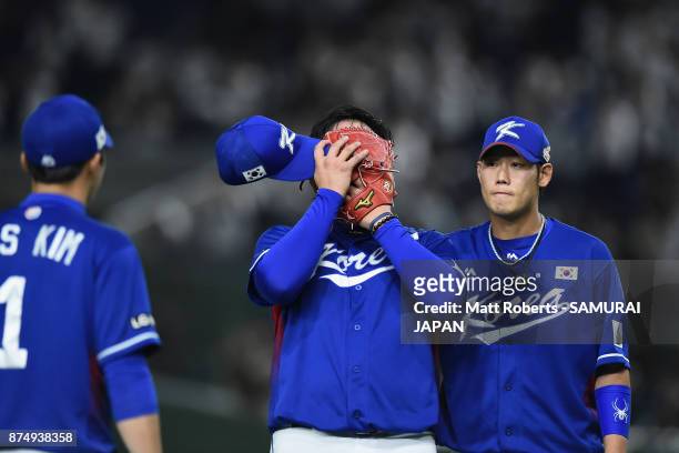 Pitcher Lee Minho of South Korea shows dejection after allowing a game-winning double to Catcher Tatsuhiro Tamura of Japan in the bottom of tenth...