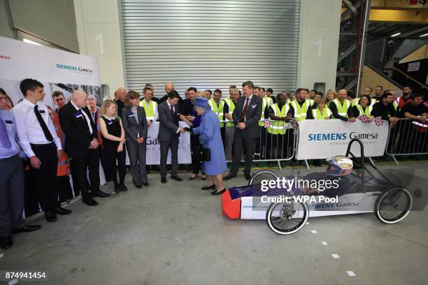 Britain's Queen Elizabeth II is accompanied by Managing Director of the Wind Power Division at Siemens, Clark MacFarlane during her visit to the...