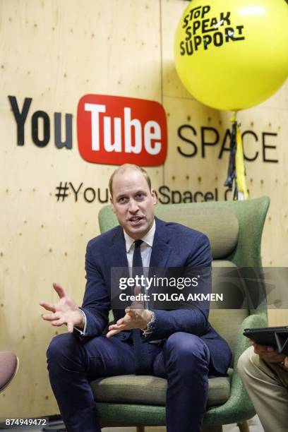 Britain's Prince William, Duke of Cambridge speaks with volunteers from National Society for the Prevention of Cruelty to Children during his visit...