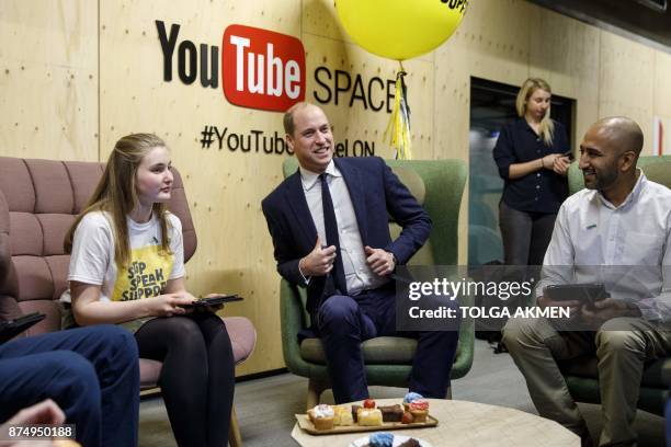 Britain's Prince William, Duke of Cambridge meets with volunteers from National Society for the Prevention of Cruelty to Children during his visit to...