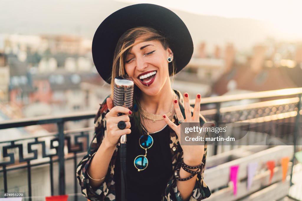 Girl singing on rooftop party