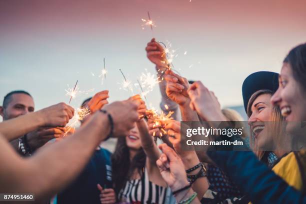 friends celebrating new year - sparklers stock pictures, royalty-free photos & images