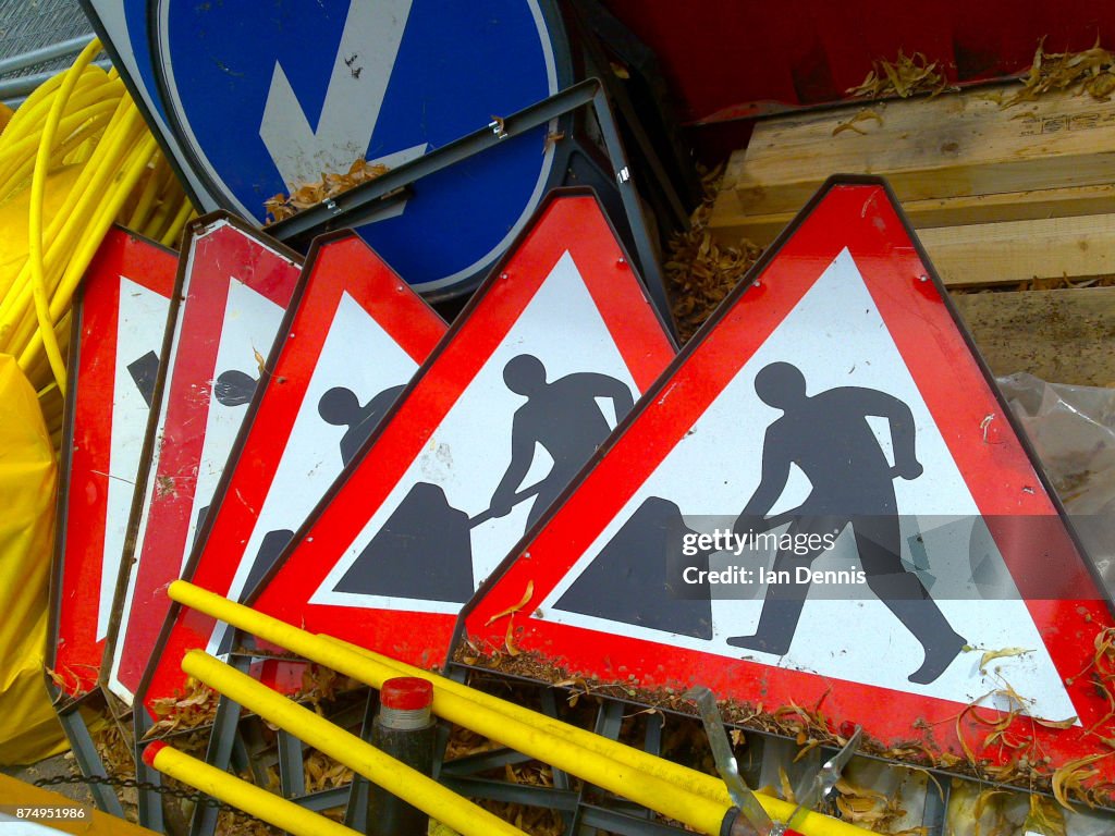 Pile of Men at work signs