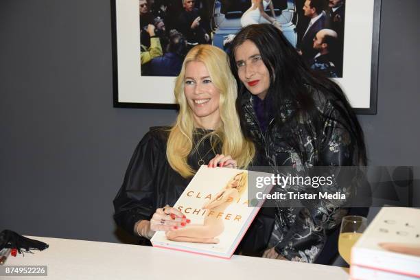 Model Claudia Schiffer signs a copy of her book for Anja Kossiwakis during the launch of the photo book 'Claudia Schiffer' at CWC Gallery on November...