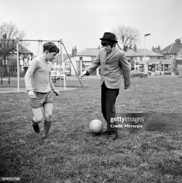 Actor Jack Wild who played the role of the Artful Dodger in the 1968 Lionel Bart musical film Oliver! Pictured playing football with another boy in...